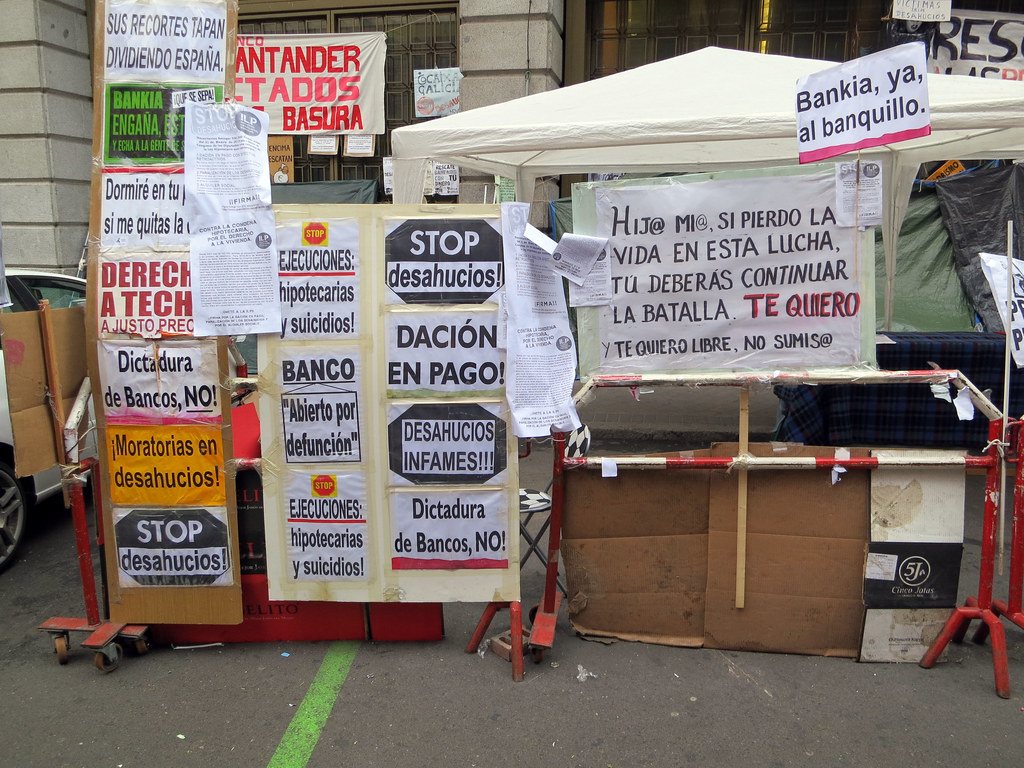 Protest signs against evictions during the Madrid housing crisis protests